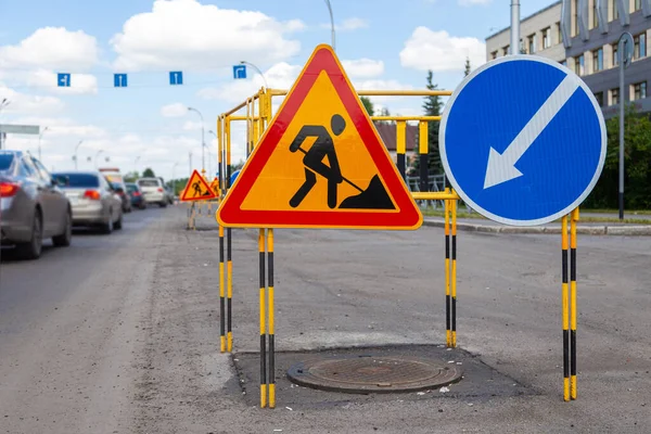 Asfalt wegreparaties, gele waarschuwingsdriehoek borden over wegwerkzaamheden en bypass richtingen — Stockfoto