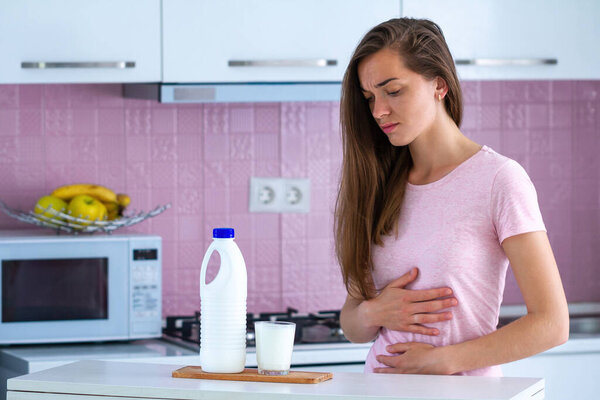 Стресс грустной несчастной женщины, страдающей от аллергии на молоко и расстройства, боли в животе от непереносимости лактозы.
