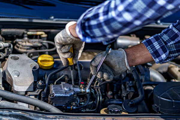 Auto mechanic repairing a car engine. Repair service 