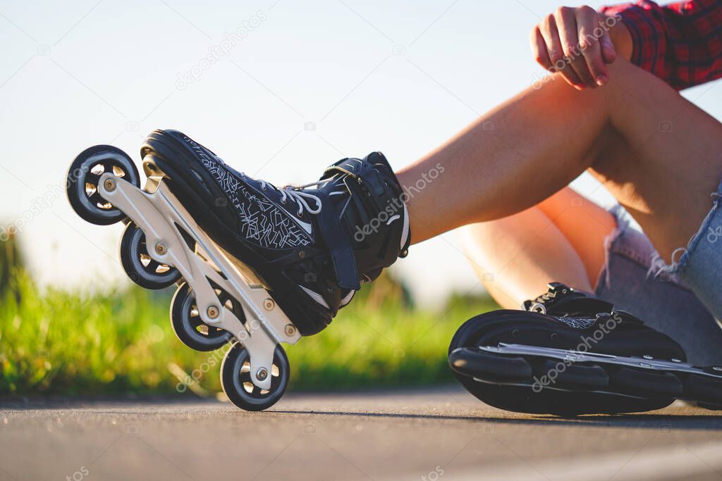 Woman in roller skates during inline skating outdoors. Active lifestyle. Teenager during rollerblading