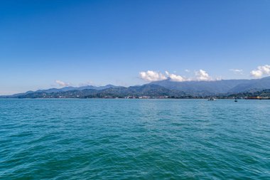 Scenery of black sea on a background of mountains in Batumi, Georgia on a sunny clear day