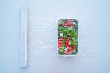 Evdeki buzdolabında yiyecek depolamak için polietilen plastik film kullanıyorum. Üst Manzara. Gıda koruması
