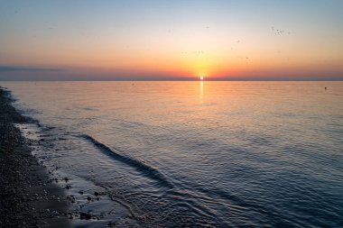 Texture of calm sea and sunset