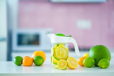 Glass jug with refreshing infused detoxification citrus water for vitamin detox drink. Slimming antioxidant drinks for diet healthy drinking 