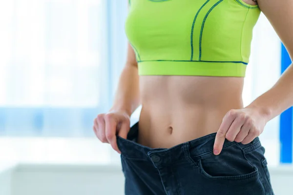 Healthy Sport Fitness Slim Woman Pulling Her Large Jeans Showing — ストック写真