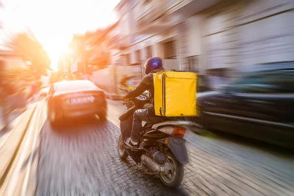 Fast and free delivery food by scooter in the afternoon in the city 