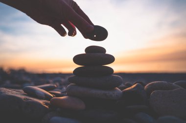 Stone with a hole at sunset. Find a mascot and make a wish