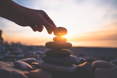 Stone with a hole at sunset. Find a talisman and make a wish