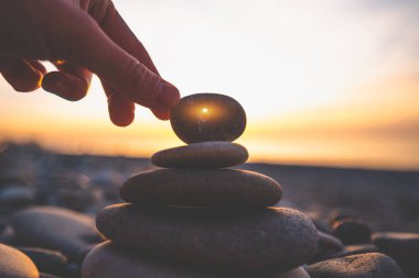 Pyramid with a stone with a hole at sunset. Find an amulet chicken god and make a wish