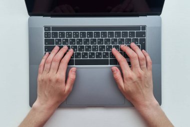 İnternette çalışırken dizüstü bilgisayarda yazı yazan bir kadın. Üst görünüm