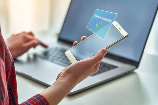 Person using laptop and mobile phone for online buying and paying goods. Modern people using e commerce and mobile payment banking