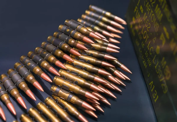 Bulk of bullets suitable for M80/M62 which are linked ammunition consisting of Lake City brass, links, boxer-primers and projectiles on a black background.