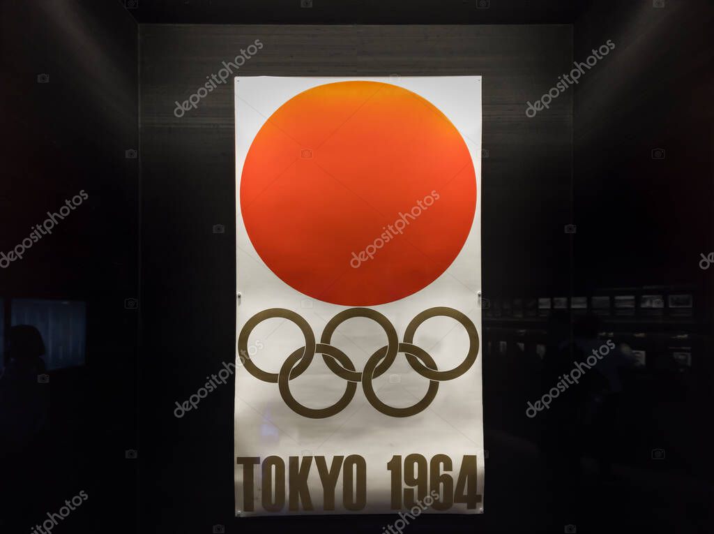 Tokyo, japan - january 15 2020: Old poster adorned with the five rings of Olympic Games and the hinomaru rising sun symbol used during the Tokyo 1964 Summer Olympics games in the Japan Olympic Museum.