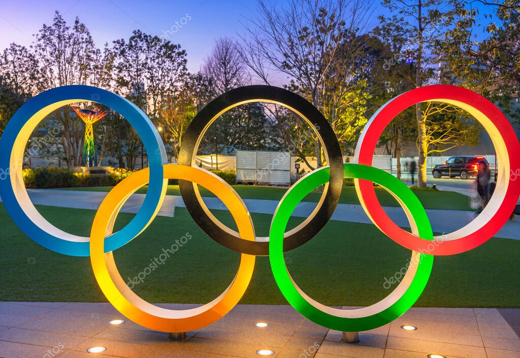 Tokyo, japan - may 10 2021: Olympic Rings monument lighted up at dusk on the japan sport olympic square of the Japan Olympic Museum created for promoting the Tokyo Olympic and Paralympic Games in 2021