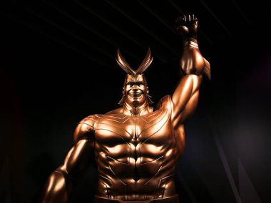 tokyo, japan - june 03 2021: Close up on the golden sculpture of the superhero All Might raising his fist in the air and standing at the exit of the My Hero Academia exhibition in Roppongi Hills.