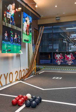 tokyo, japan - august 30 2021: Jack ball, soft bocce balls and ramp made for disabled athletes in boccia sport exhibited at Paralympic Gallery Ginza with Someity mascot of Tokyo 2020 Paralympics Games clipart