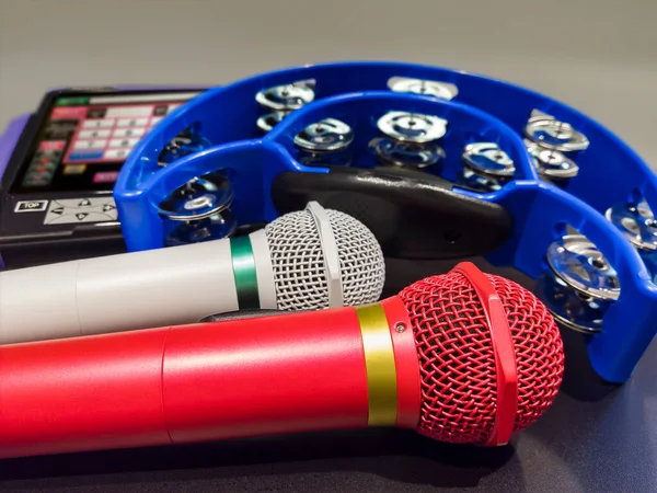 Closeup Two Microphones Table Karaoke Club Remote Controller Tambourine Used — Stock Photo, Image