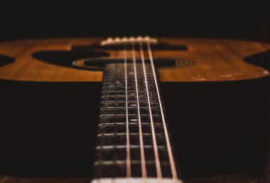 Close up old acoustic guitar in vintage filter