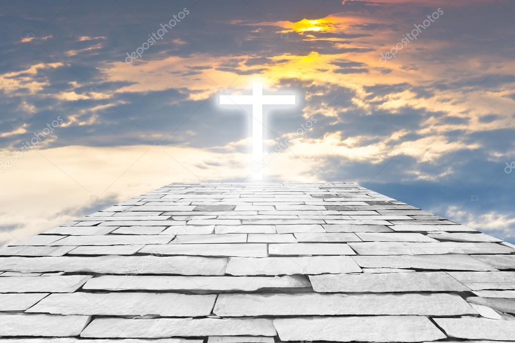 Brick road to a transparent cross giving out heavenly light on t