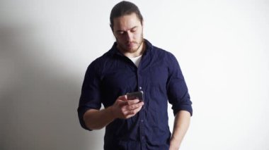 Kızıl sakallı, uzun saçlı, sportif bir adam akıllı telefondan kitap okuyor.