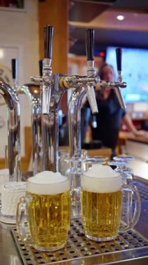 Barmen dikkatle bardağı doldurur. Soğutulmuş bira bardağı pürüzsüzce doldurur. Buz Birası deneysel olarak soğuk bardağa dökülür. Yetenekli barmen buz gibi birayı titizlikle soğuk bardağa dolduruyor.