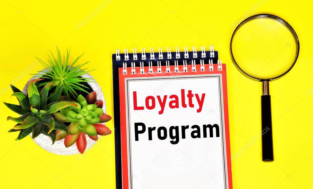 Loyalty program. Text label in the planning notebook. A set of marketing activities for the development and promotion of corporate ideas and values.