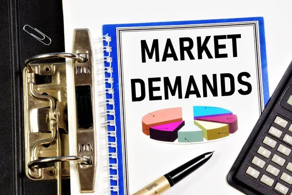 Market demands. A text label in the planning notebook. Market analysis, successful business strategy.