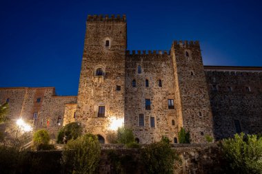 View of the walls of the Royal Monastery of Our Lady of Guadalupe in Caceres, Extremadura, Spain, a UNESCO World Heritage Site, at night