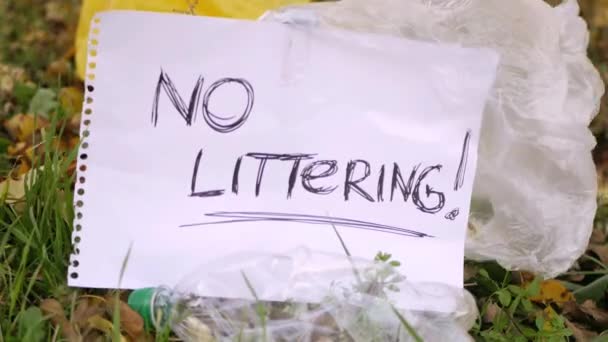 Littering Sign Park Surrounded Plastic Trash Polyethylene Bags Video Sound — Stock Video