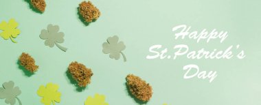 Saint Patrick's Day pattern. Cannabis buds with four leaf clover pattern. Copy space.  clipart