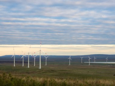 Yel değirmenli manzara. Bir tepenin üzerinde bulunan rüzgar türbini.