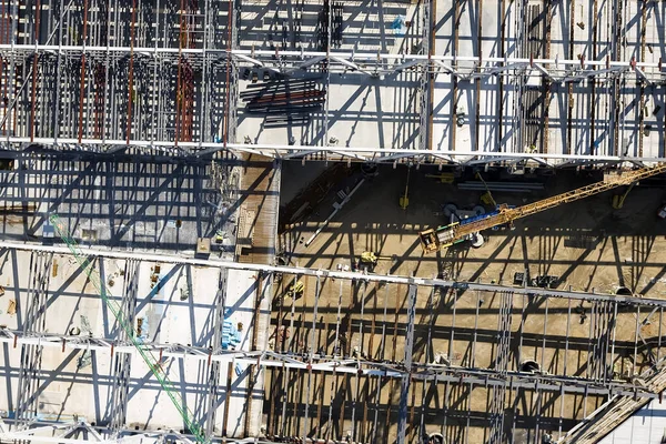 Aerial view of busy industrial construction site workers with cranes working.