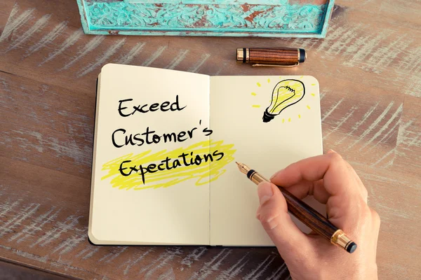 Handwritten text Exceed Customer's Expectations — 스톡 사진