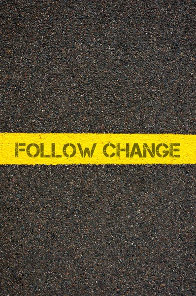 Road marking yellow line with words FOLLOW CHANGE — Stock Photo, Image