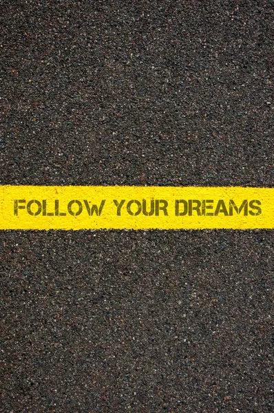 Road marking yellow line with words FOLLOW YOUR DREAMS — 스톡 사진