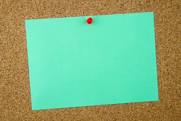 Blank turquoise paper note pinned on cork board — Stock Photo, Image