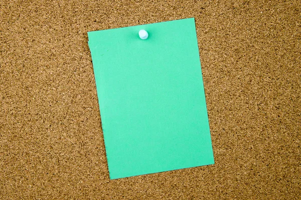 Blank turquoise paper note pinned on cork board — Stock Photo, Image