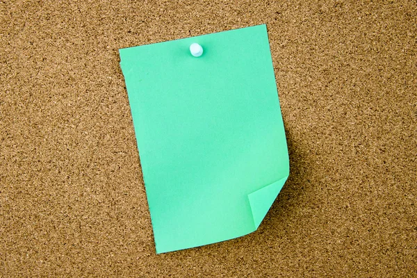 Blank turquoise paper note pinned on cork board — Stock Photo, Image