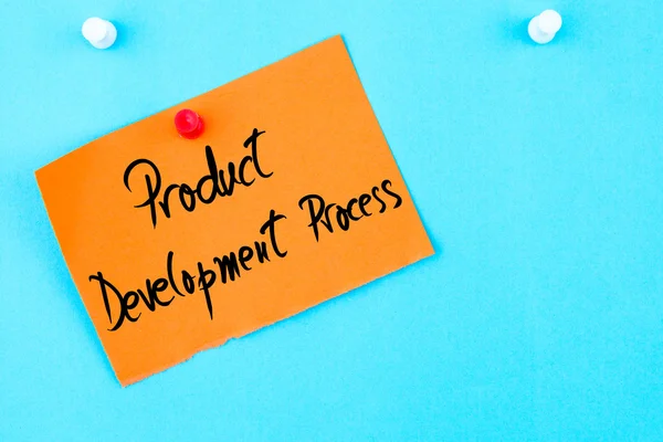 Proceso de desarrollo del producto escrito en papel naranja — Foto de Stock