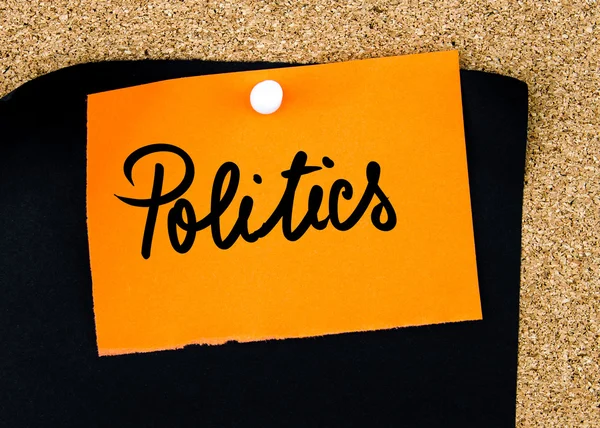 Politics written on orange paper note — Stock Photo, Image