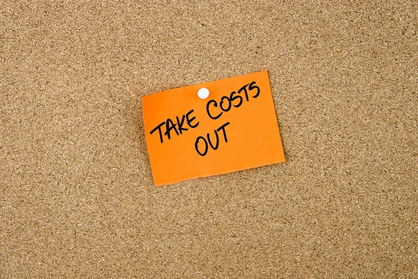 TAKE COSTS OUT written on orange paper note — Stock Photo, Image