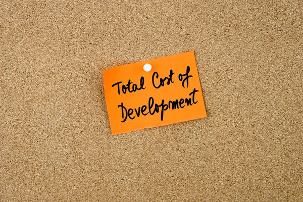 TCD as Total Cost Of Development written on orange paper note — Stock Photo, Image