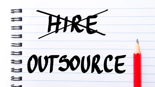 Outsource instead of Hire written on notebook page — Stock Photo, Image