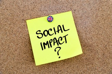 Yellow paper note pinned with Great Britain flag thumbtack and text SOCIAL IMPACT ?