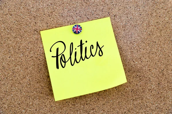 Yellow paper note pinned with Great Britain flag thumbtack and text POLITICS — Stock Fotó