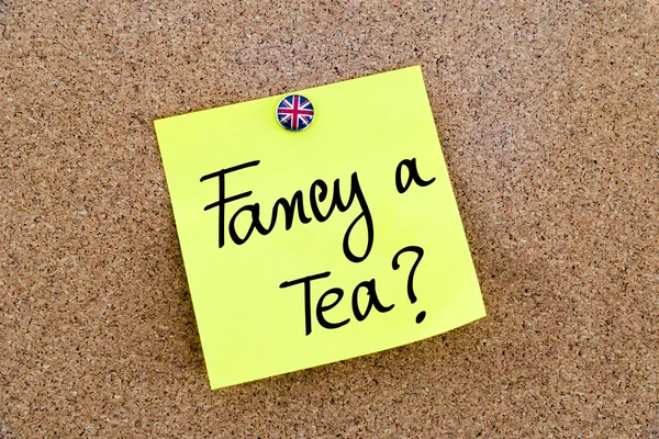 Yellow paper note pinned with Great Britain flag thumbtack and text FANCY A TEA ? — 스톡 사진