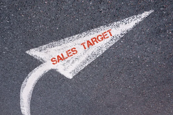 Flecha pintada blanco direccional con palabras VENTAS TARGET sobre la superficie de la carretera — Foto de Stock