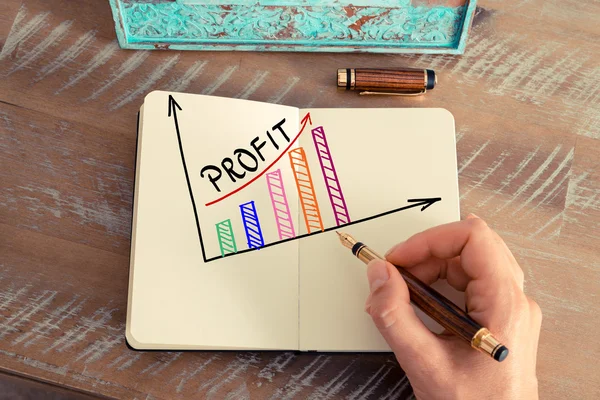Business woman drawing a colourful PROFIT graph — Stock Photo, Image