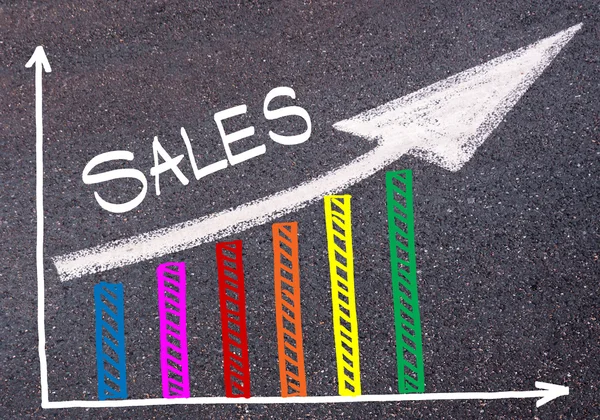 Colorful graph drawn over tarmac and directional arrow — Stock Photo, Image