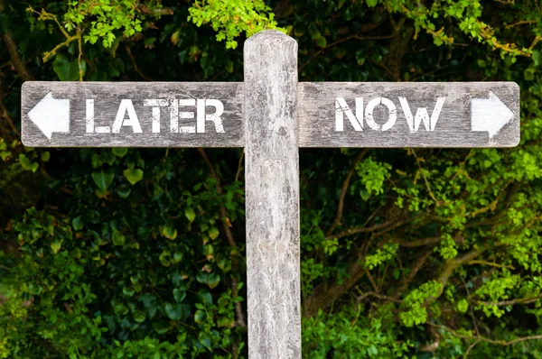 LATER versus NOW directional signs — Stock Photo, Image